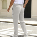 Back view of pants showing rear pocket design and overall silhouette, man with hand in back pocket for storage detail.