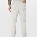 Close-up of back pocket and elastic waistband, emphasizing storage functionality and comfort in multipants.
