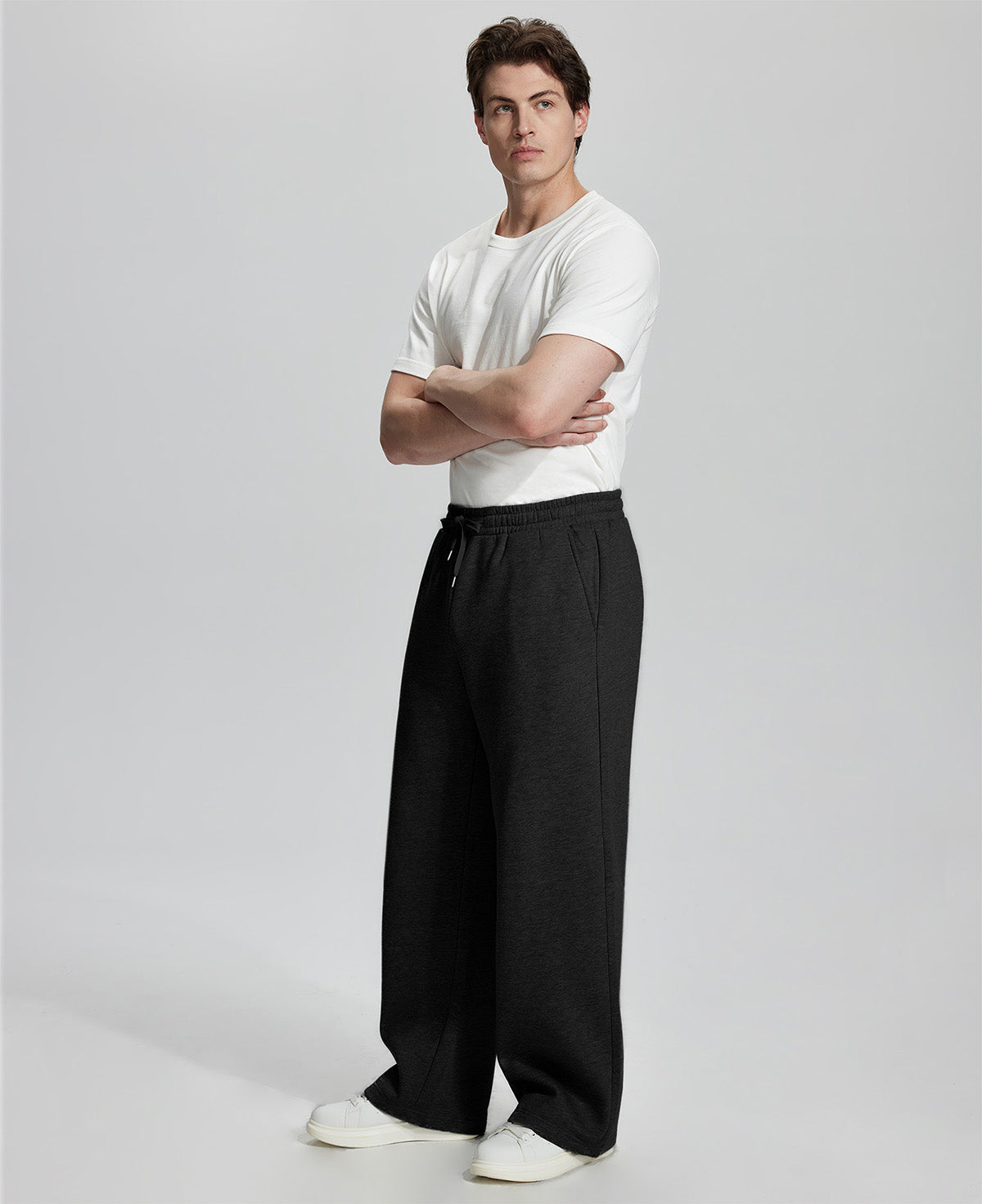 Side view of Men's Fleece Sweatpants ¨C wide-leg silhouette and cozy drape for ultimate comfort.