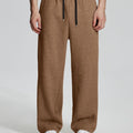 Model in coffee Men's Fleece Sweatpants ¨C Wide Leg Heavyweight Lounge Pants with white sneakers, showing drape and relaxed fit.