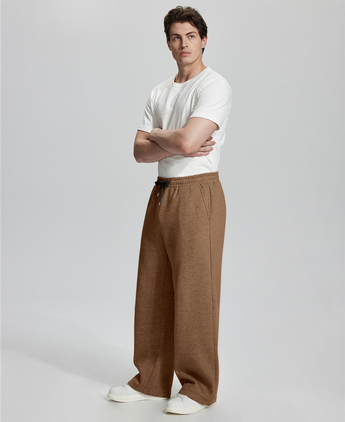 Side view of Men's Fleece Sweatpants ¨C wide-leg silhouette and cozy drape for ultimate comfort.
