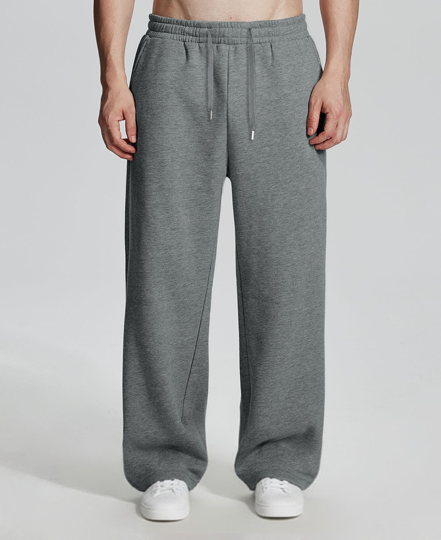 Model in dark grey Men's Fleece Sweatpants ¨C Wide Leg Heavyweight Lounge Pants with white sneakers, showing drape and relaxed fit.