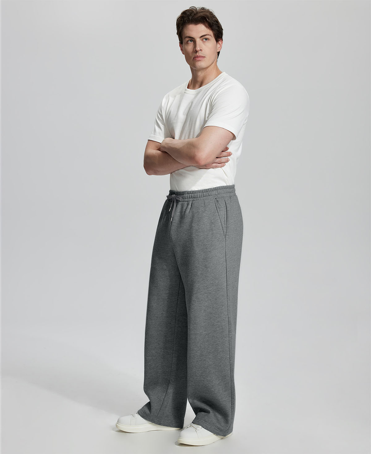 Side view of Men's Fleece Sweatpants ¨C wide-leg silhouette and cozy drape for ultimate comfort.