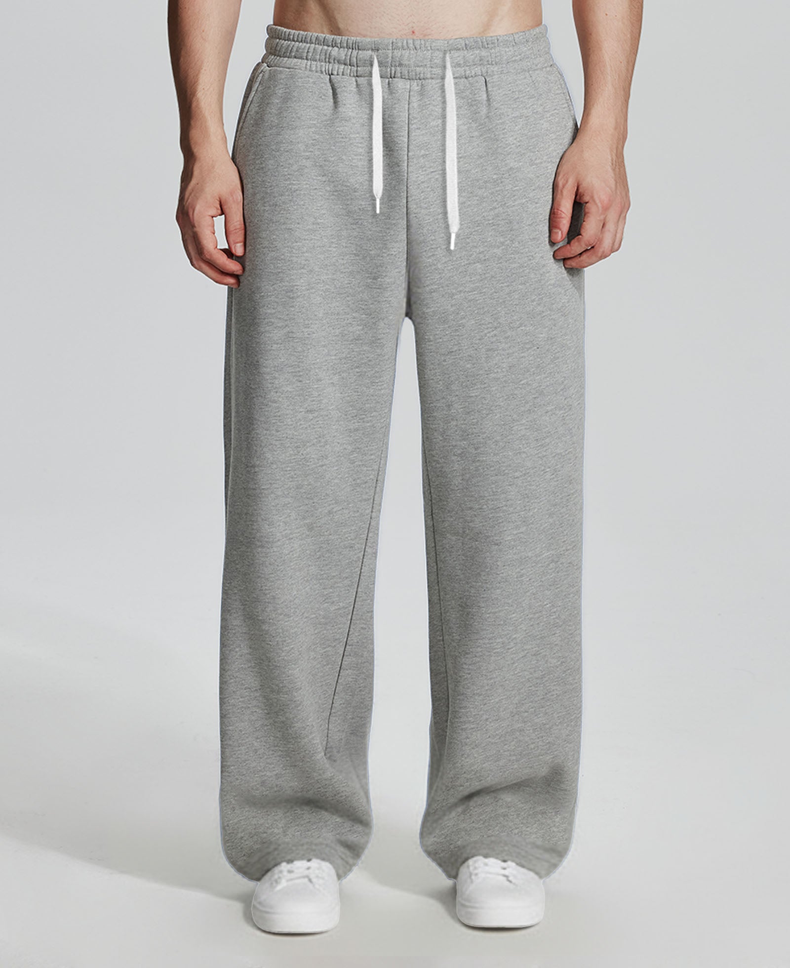 Model in light grey Men's Fleece Sweatpants ¨C Wide Leg Heavyweight Lounge Pants with white sneakers, showing drape and relaxed fit.
