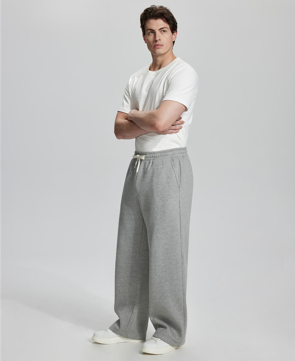 Side view of Men's Fleece Sweatpants ¨C wide-leg silhouette and cozy drape for ultimate comfort.