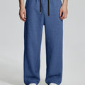 Model in navy Men's Fleece Sweatpants ¨C Wide Leg Heavyweight Lounge Pants with white sneakers, showing drape and relaxed fit.