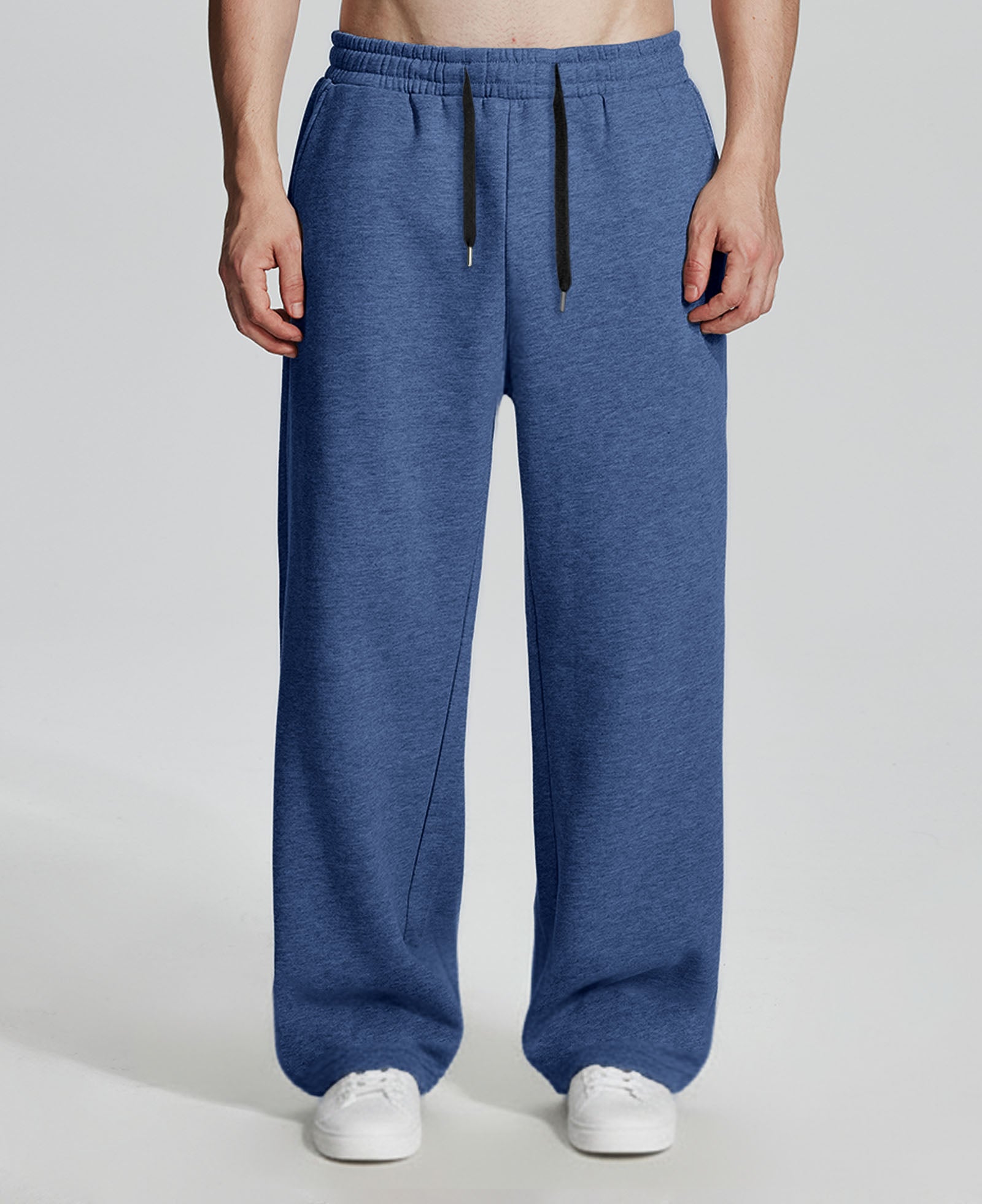 Model in navy Men's Fleece Sweatpants ¨C Wide Leg Heavyweight Lounge Pants with white sneakers, showing drape and relaxed fit.