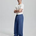 Side view of Men's Fleece Sweatpants ¨C wide-leg silhouette and cozy drape for ultimate comfort.