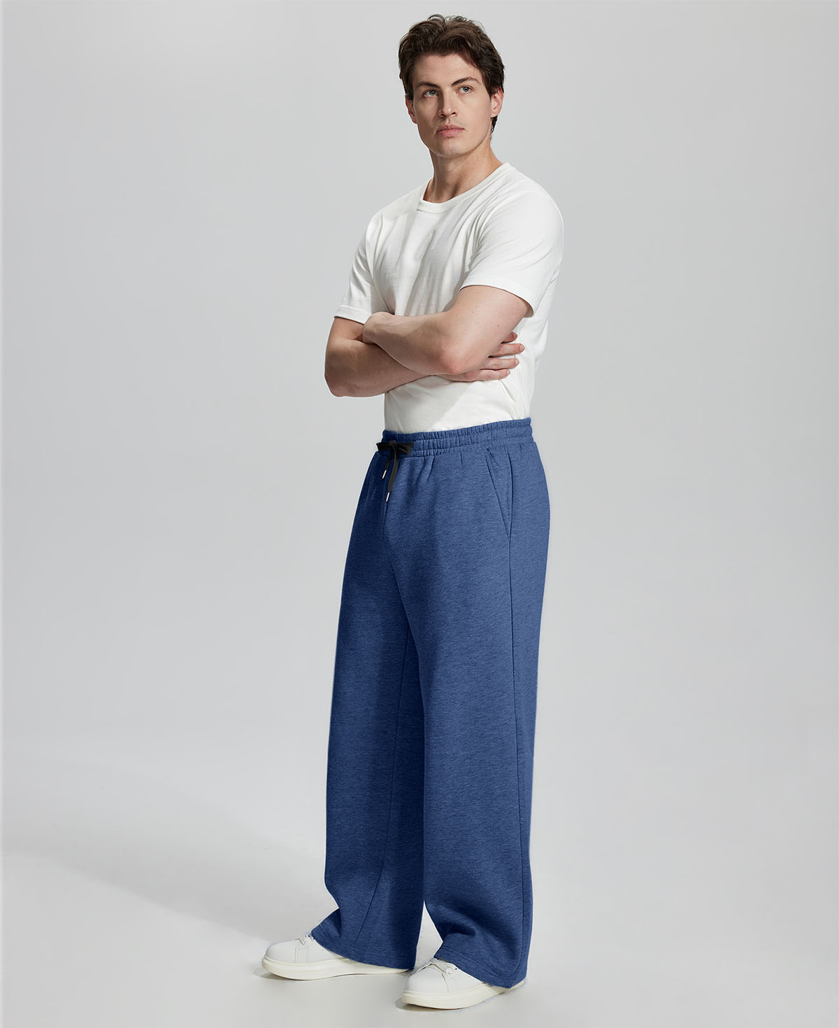 Side view of Men's Fleece Sweatpants ¨C wide-leg silhouette and cozy drape for ultimate comfort.