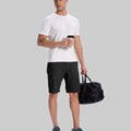 Model in white tee, black Men's Golf & Hiking Shorts, and blue-gray sneakers with coffee cup¡ªshowing casual wear styling.