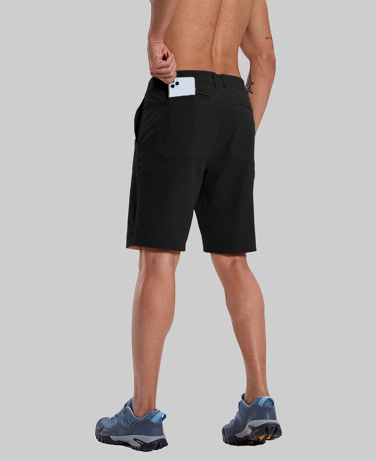 Back view of model with phone in back pocket of black shorts¡ªshowing storage space and rear silhouette design.