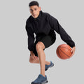 Model playing basketball in black jacket and black Men's Golf & Hiking Shorts¡ªdemonstrating versatility in sports settings.