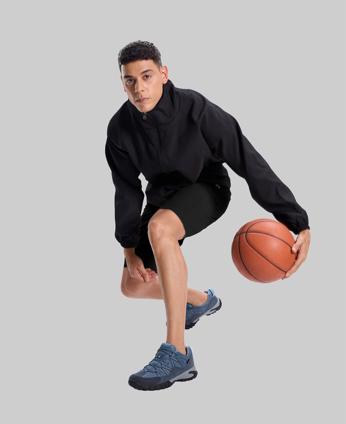 Model playing basketball in black jacket and black Men's Golf & Hiking Shorts¡ªdemonstrating versatility in sports settings.