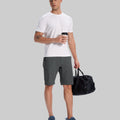 Model in white tee, dark grey Men's Golf & Hiking Shorts, and blue-gray sneakers with coffee cup¡ªshowing casual wear styling.