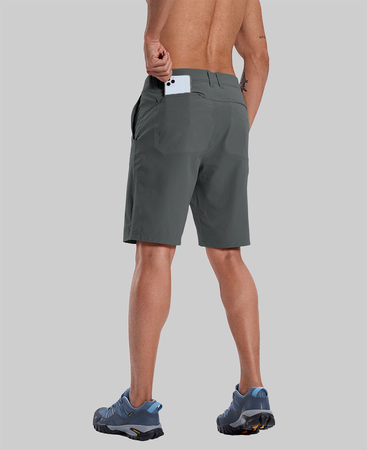 Back view of model with phone in back pocket of dark grey shorts¡ªshowing storage space and rear silhouette design.