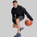 Model playing basketball in black jacket and dark grey Men's Golf & Hiking Shorts¡ªdemonstrating versatility in sports settings.