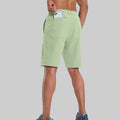 Back view of model with phone in back pocket of light green shorts¡ªshowing storage space and rear silhouette design.