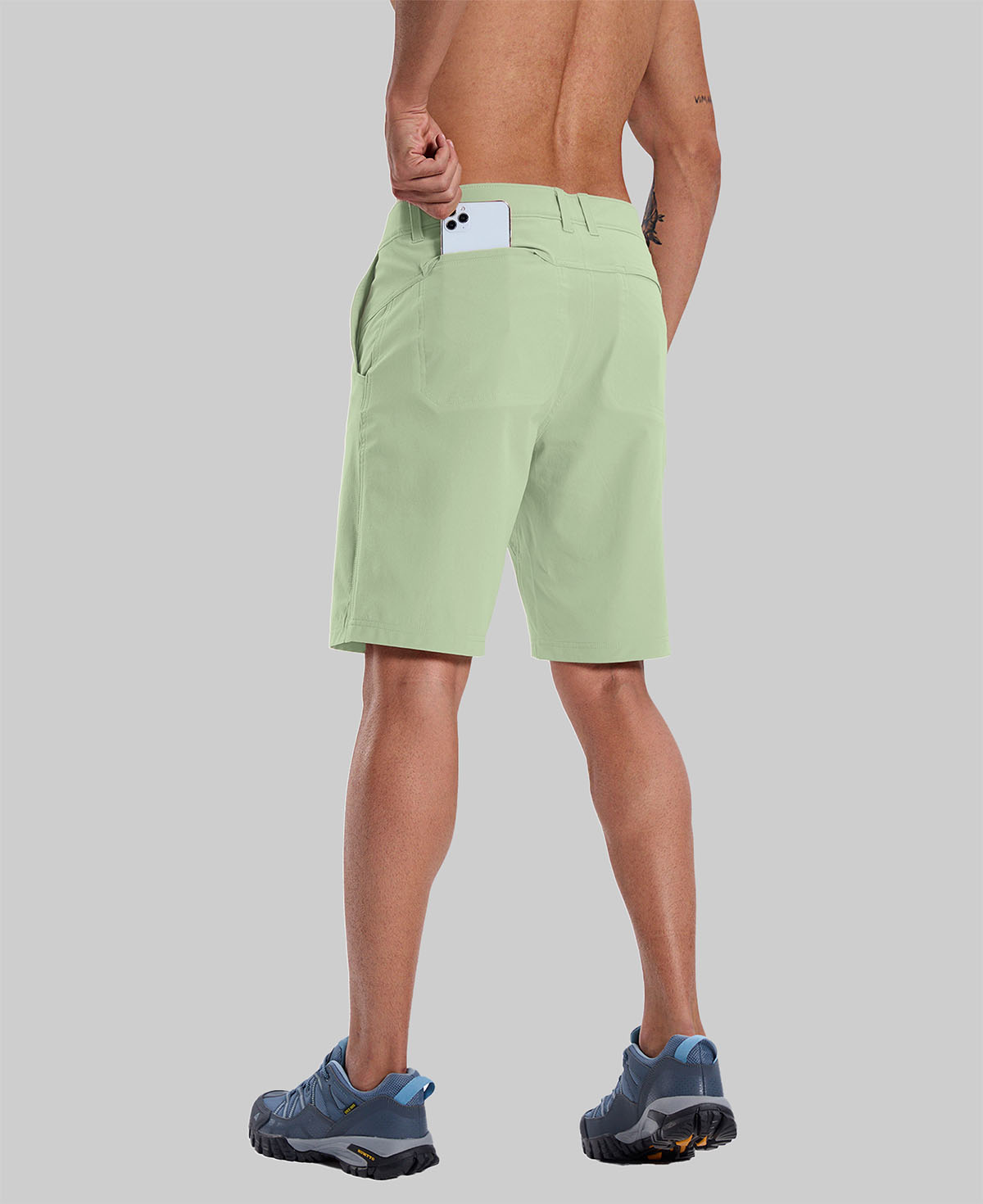 Back view of model with phone in back pocket of light green shorts¡ªshowing storage space and rear silhouette design.