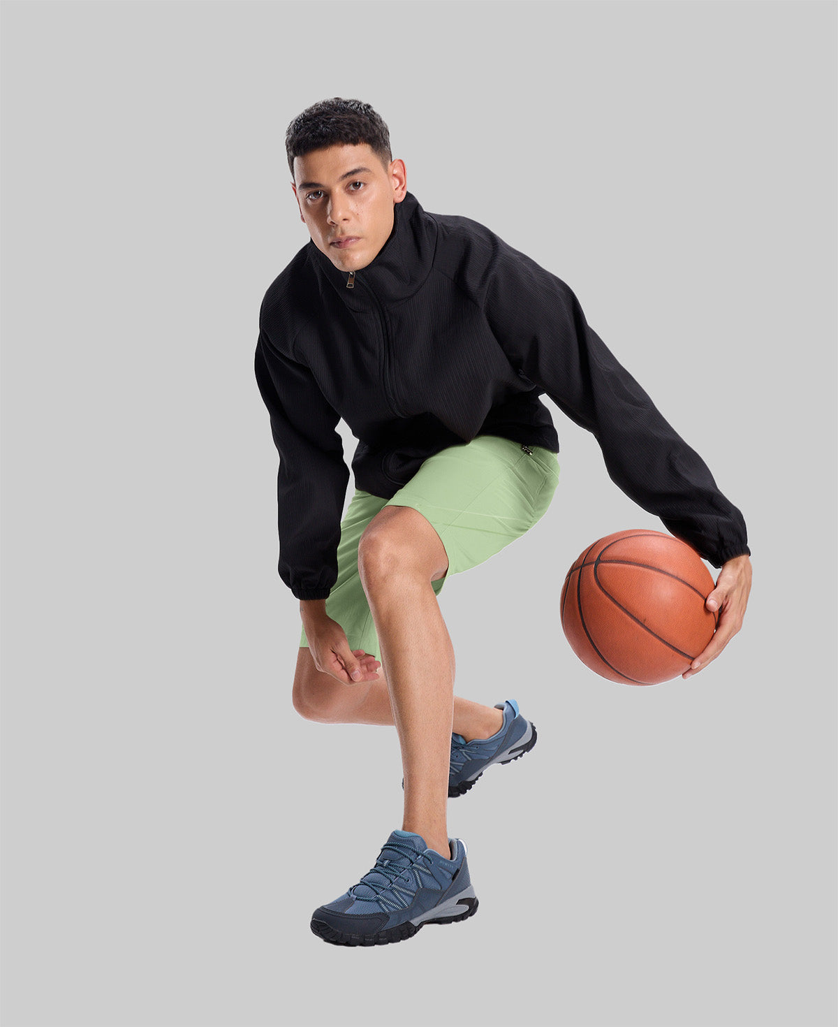 Model playing basketball in black jacket and light green Men's Golf & Hiking Shorts¡ªdemonstrating versatility in sports settings.