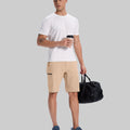 Model in white tee, khaki Men's Golf & Hiking Shorts, and blue-gray sneakers with coffee cup¡ªshowing casual wear styling.