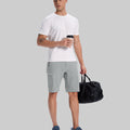 Model in white tee, light gray Men's Golf & Hiking Shorts, and blue-gray sneakers with coffee cup¡ªshowing casual wear styling.