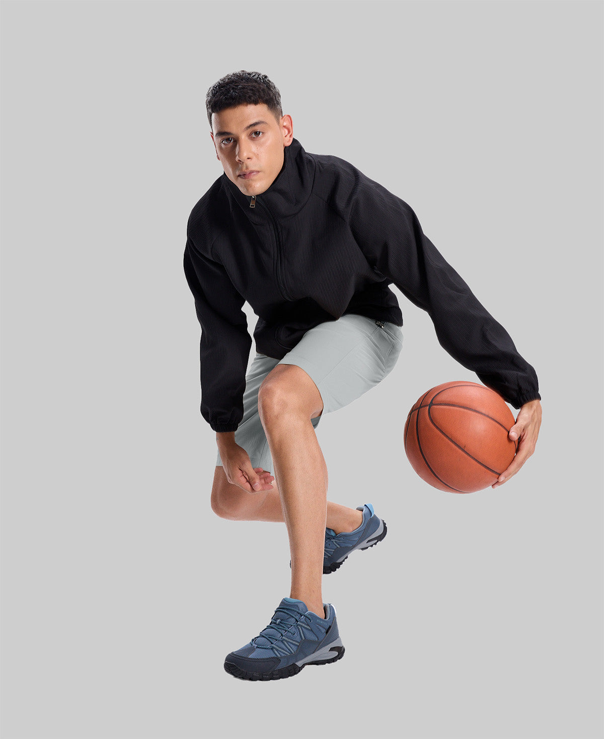 Model playing basketball in black jacket and light gray Men's Golf & Hiking Shorts¡ªdemonstrating versatility in sports settings.