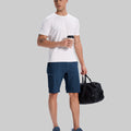 Model in white tee, navy blue Men's Golf & Hiking Shorts, and blue-gray sneakers with coffee cup¡ªshowing casual wear styling.
