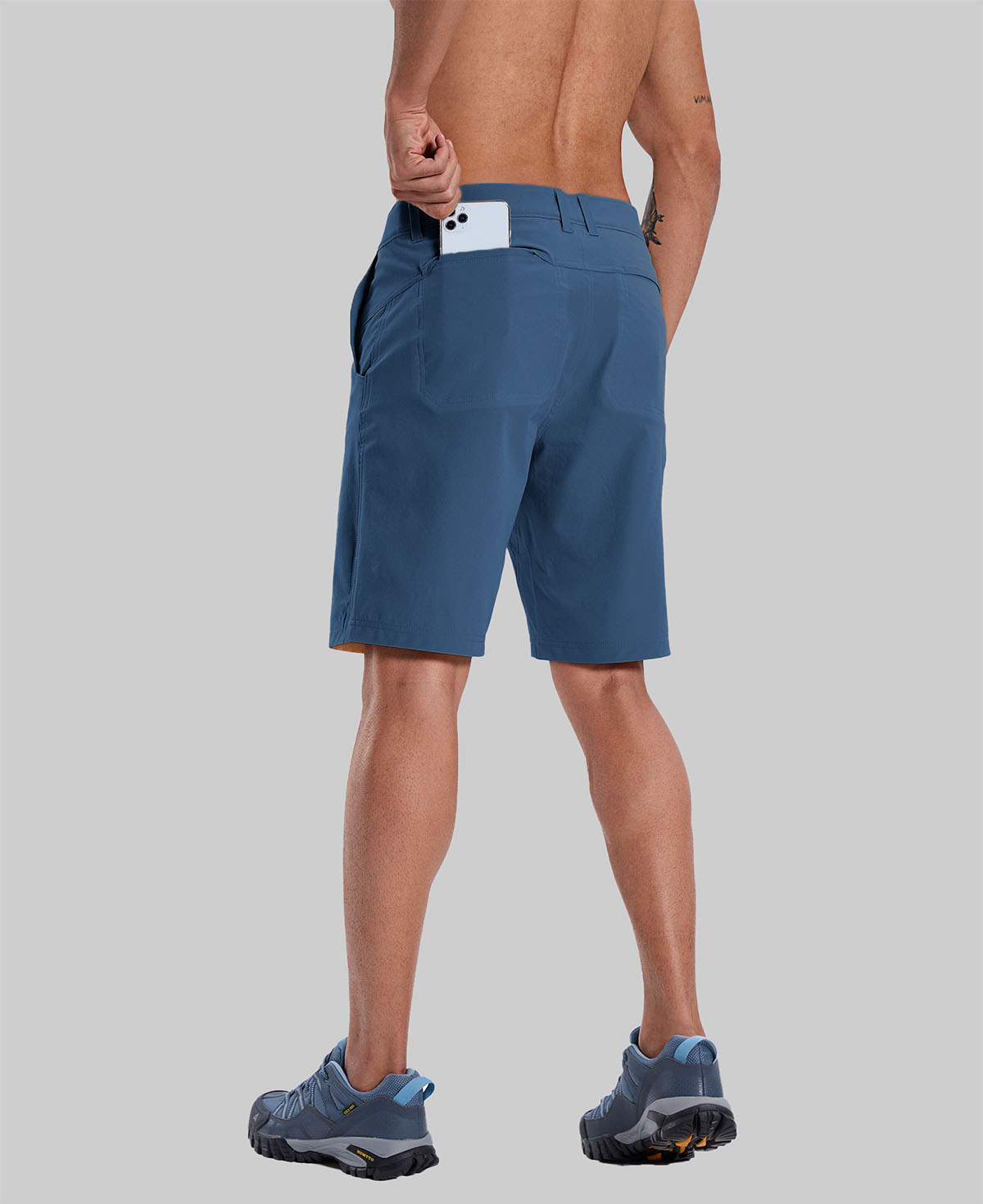 Back view of model with phone in back pocket of navy blue shorts¡ªshowing storage space and rear silhouette design.