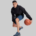 Model playing basketball in black jacket and navy blue Men's Golf & Hiking Shorts¡ªdemonstrating versatility in sports settings.