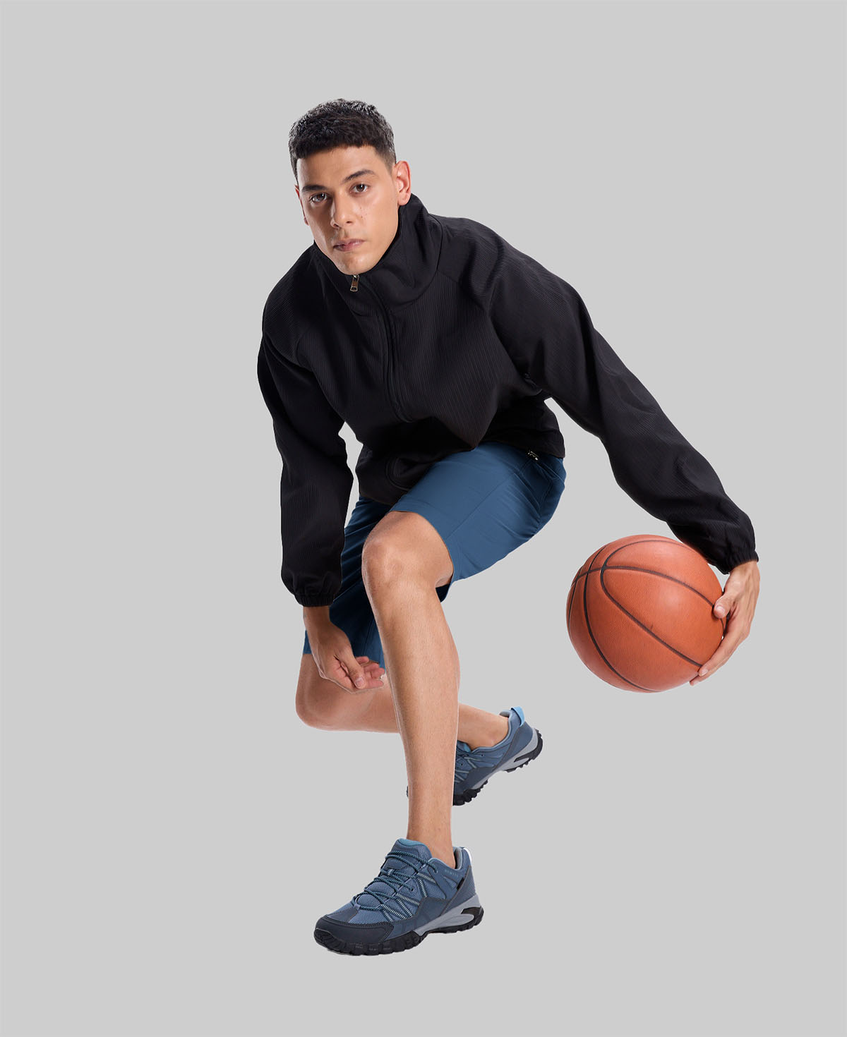 Model playing basketball in black jacket and navy blue Men's Golf & Hiking Shorts¡ªdemonstrating versatility in sports settings.