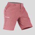 Side view of man in pink Men's Golf & Hiking Shorts, showing front pockets, button waistband, and side zip pocket details.