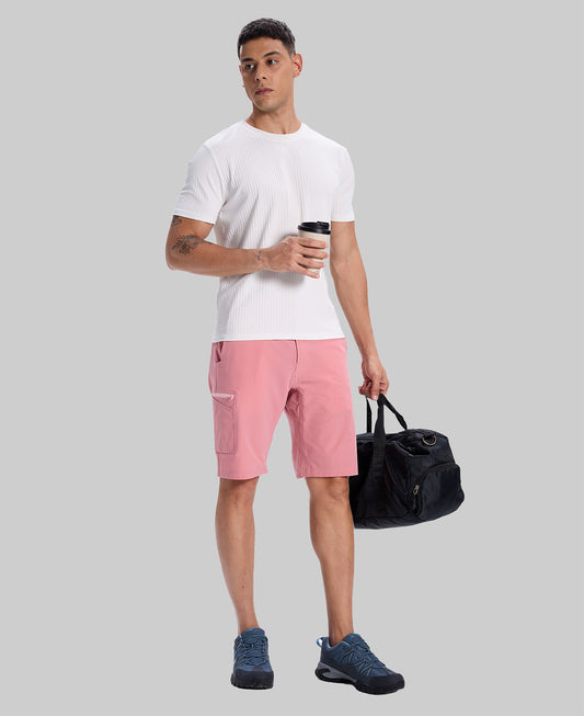 Model in white tee, pink Men's Golf & Hiking Shorts, and blue-gray sneakers with coffee cup¡ªshowing casual wear styling.