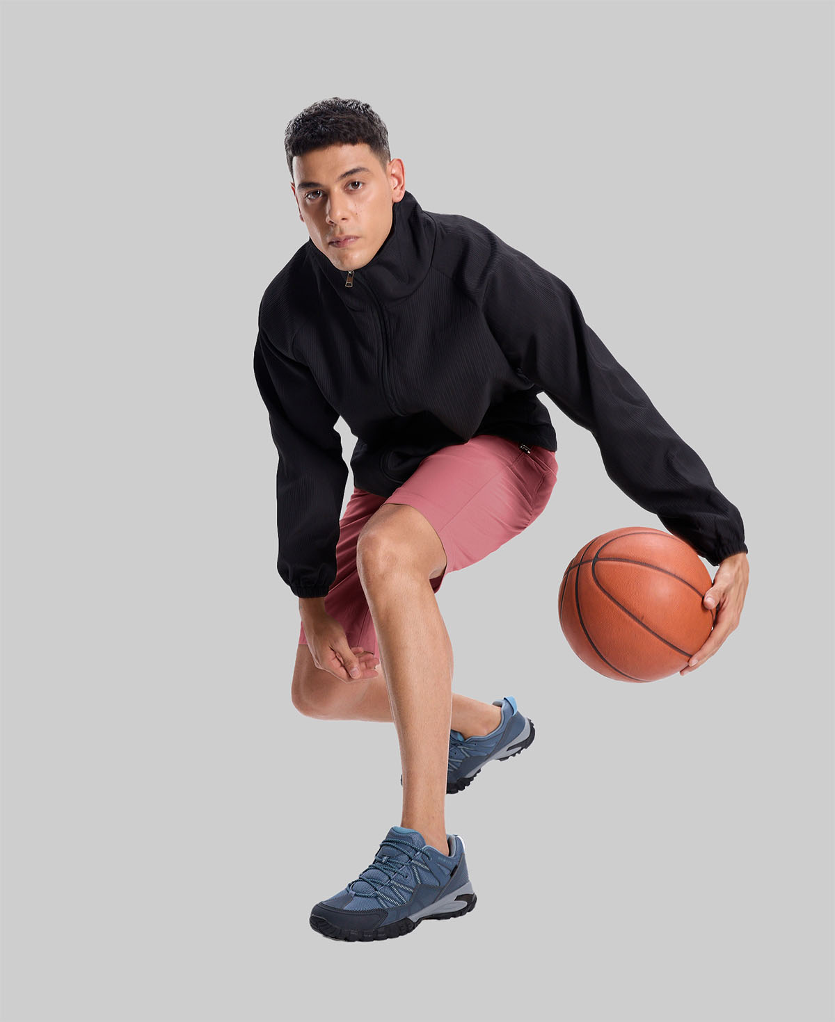 Model playing basketball in black jacket and pink Men's Golf & Hiking Shorts¡ªdemonstrating versatility in sports settings.