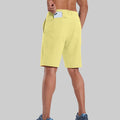 Back view of model with phone in back pocket of light yellow shorts¡ªshowing storage space and rear silhouette design.