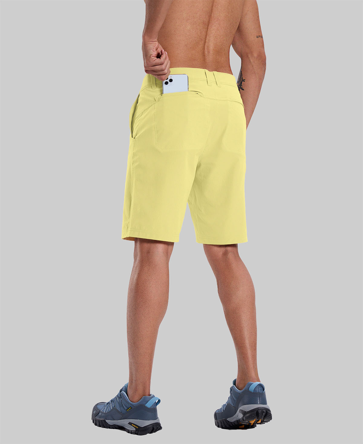 Back view of model with phone in back pocket of light yellow shorts¡ªshowing storage space and rear silhouette design.