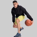 Model playing basketball in black jacket and light yellow Men's Golf & Hiking Shorts¡ªdemonstrating versatility in sports settings.