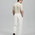 Back view of white Gurkha pants: elastic waistband and rear pockets for comfort without sacrificing silhouette.