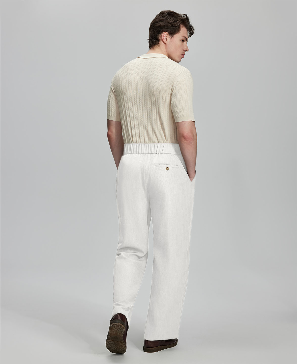 Back view of white Gurkha pants: elastic waistband and rear pockets for comfort without sacrificing silhouette.