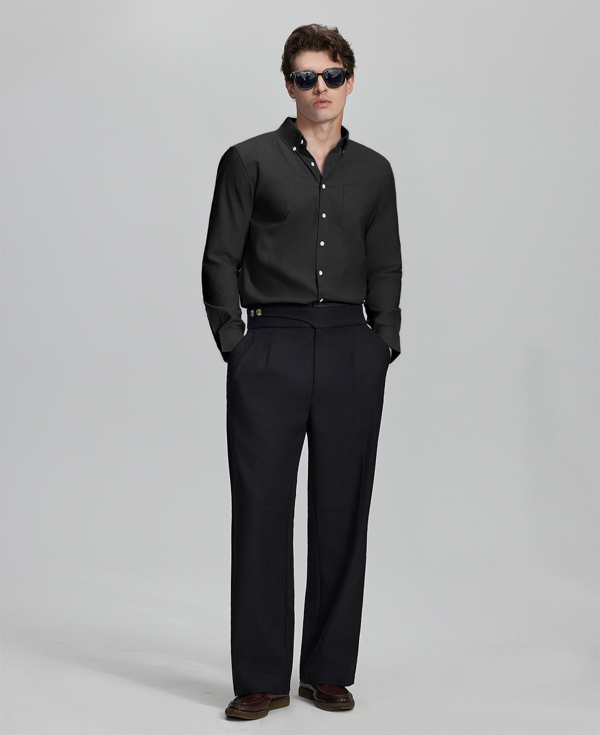 Full outfit: black Oxford shirt, wide-leg dress pants & brown shoes, minimalist yet polished style.