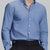 Man in deep blue Men's Oxford Button Down Dress Shirt ¨C Wrinkle Resistant, with matching trousers and hand in pocket.