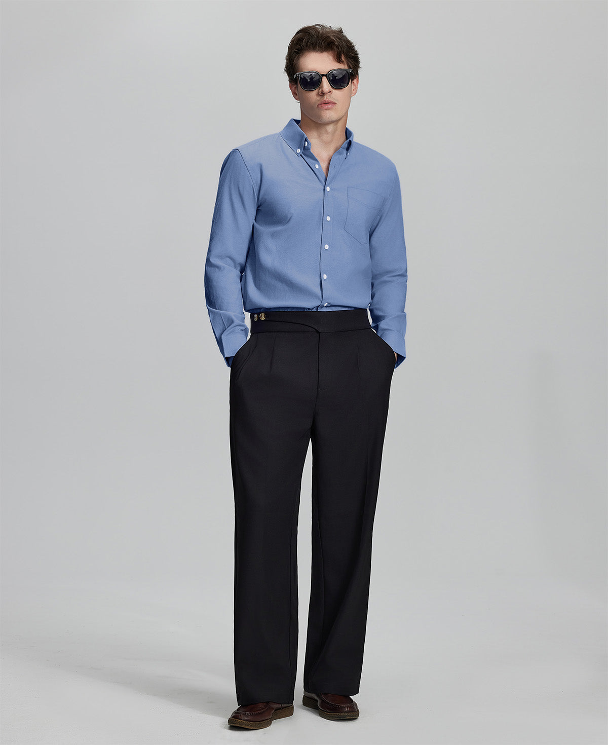 Full outfit: deep blue Oxford shirt, wide-leg dress pants & brown shoes, minimalist yet polished style.