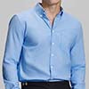 Man in light blue Men's Oxford Button Down Dress Shirt ¨C Wrinkle Resistant, with matching trousers and hand in pocket.