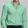 Man in light green Men's Oxford Button Down Dress Shirt ¨C Wrinkle Resistant, with matching trousers and hand in pocket.