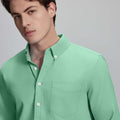 Close-up of placket, chest pocket, and buttons on wrinkle-resistant Oxford shirt, showing textured fabric quality.