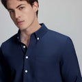 Close-up of placket, chest pocket, and buttons on wrinkle-resistant Oxford shirt, showing textured fabric quality.