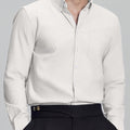 Man in white Men's Oxford Button Down Dress Shirt ¨C Wrinkle Resistant, with matching trousers and hand in pocket.