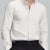 Man in white Men's Oxford Button Down Dress Shirt ¨C Wrinkle Resistant, with matching trousers and hand in pocket.
