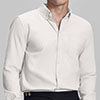 Man in white Men's Oxford Button Down Dress Shirt ¨C Wrinkle Resistant, with matching trousers and hand in pocket.