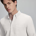 Close-up of placket, chest pocket, and buttons on wrinkle-resistant Oxford shirt, showing textured fabric quality.