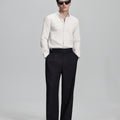 Full outfit: white Oxford shirt, wide-leg dress pants & brown shoes, minimalist yet polished style.
